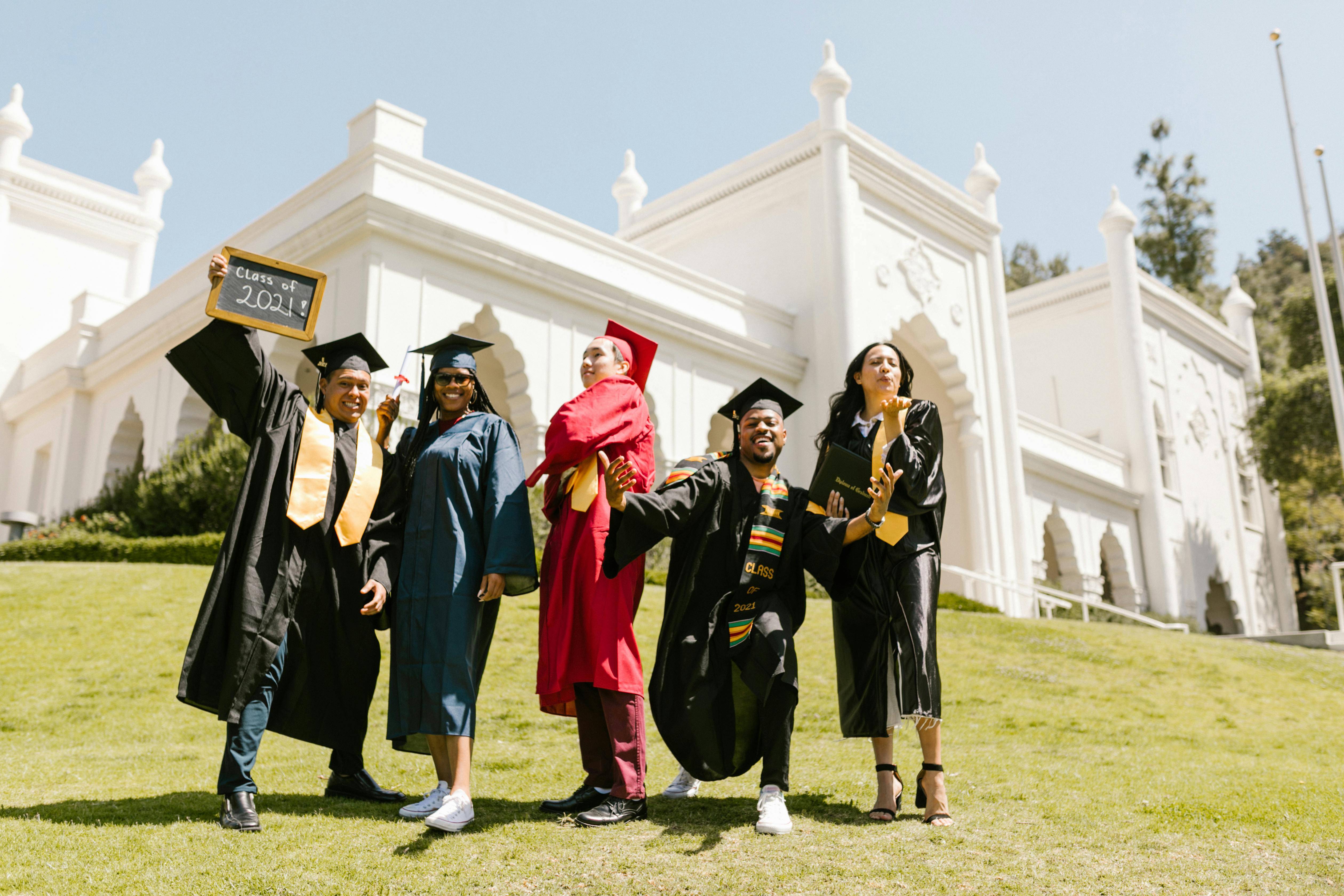 Group of graduates throwing caps